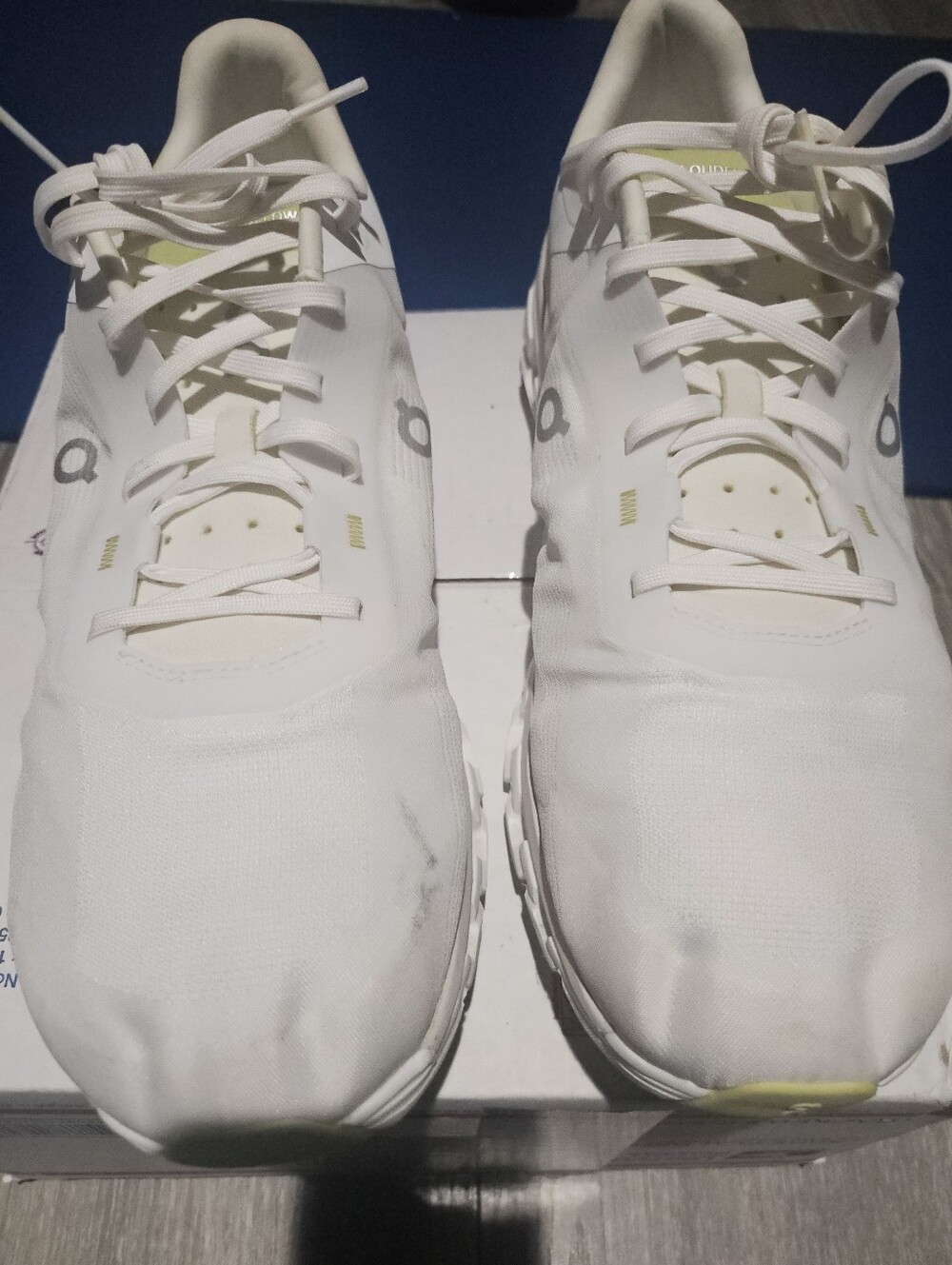 On Running White Athletic Sneakers with Subtle Yellow Accents